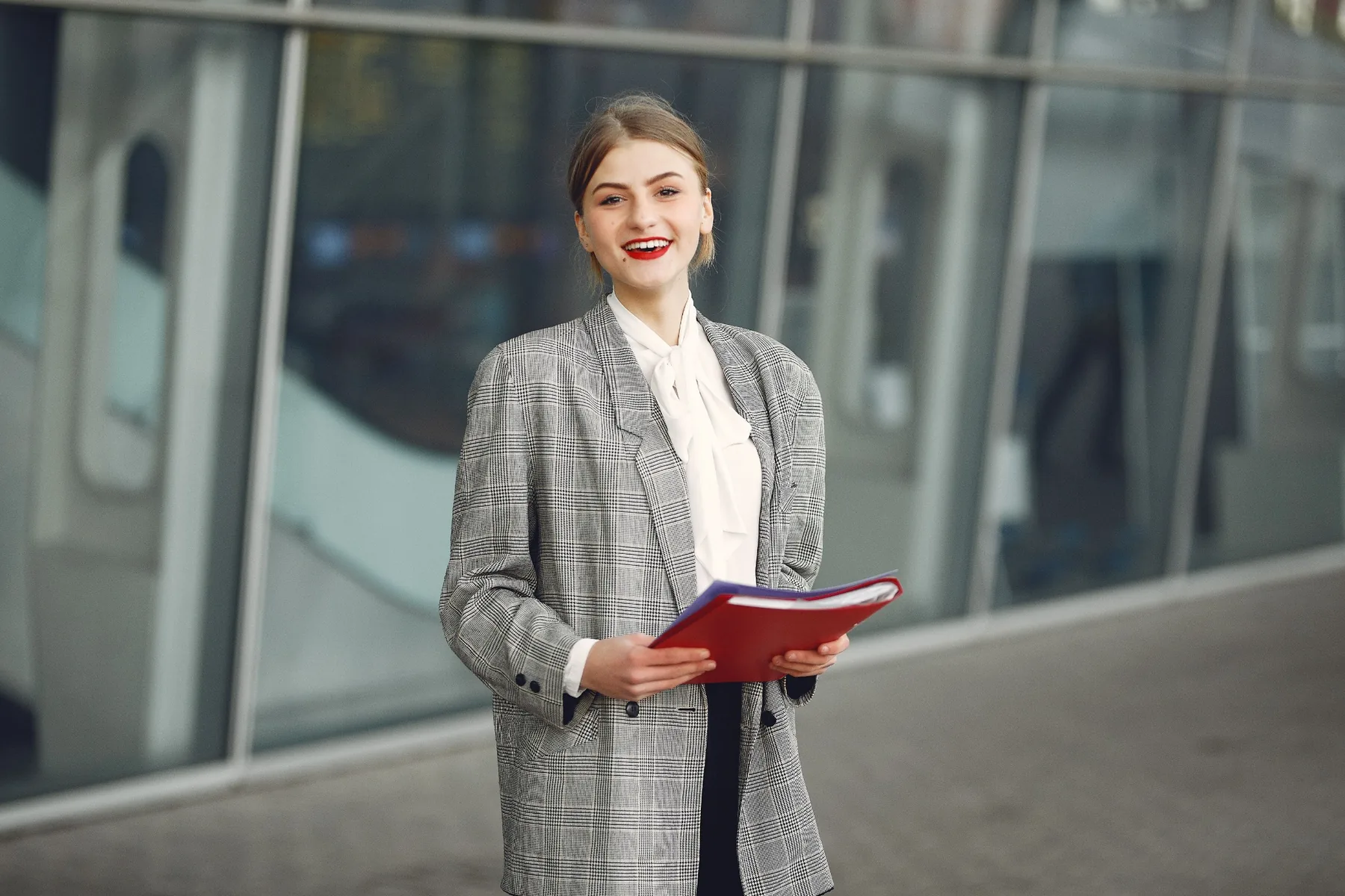 Professional reviewing a folder outside an office building