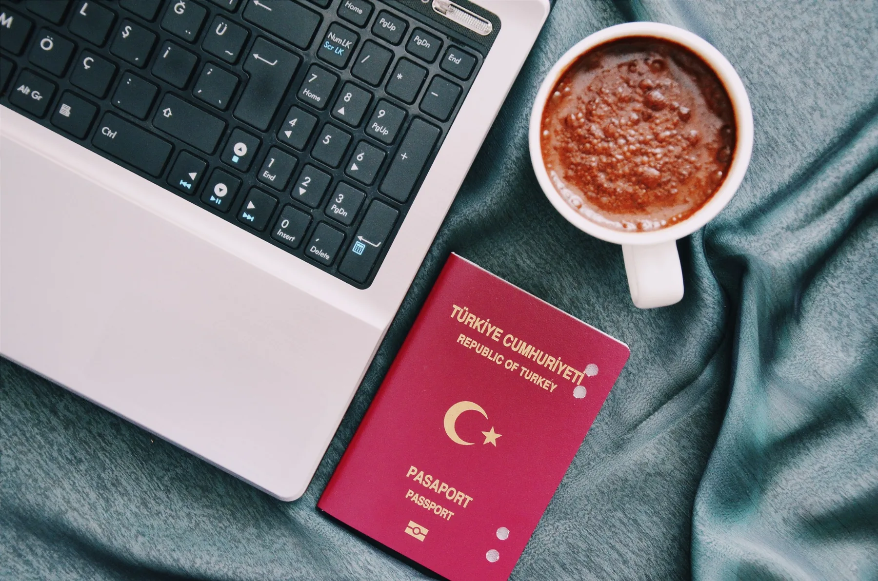 Travel document beside a laptop during document preparation