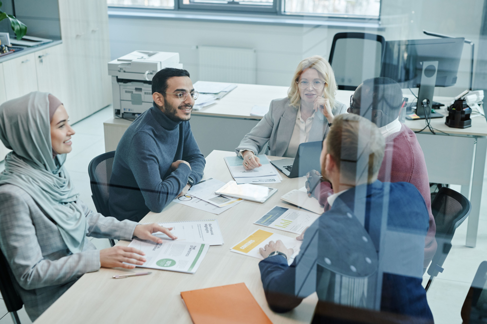 Professionals reviewing recruitment documents in a workplace setting